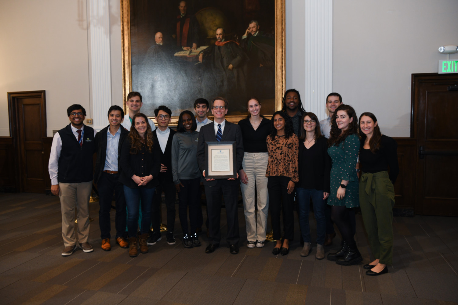 Photo of Andy Ewald surrounded by members of his lab at the Virginia DeAcetis Professorship dedication